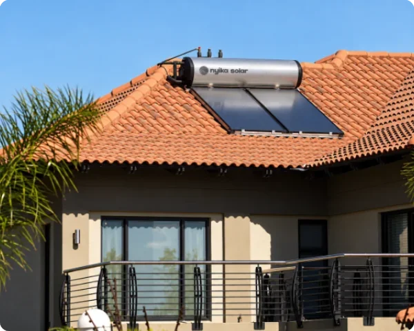 Nyika Solar integrated solar geyser with two flat-plate thermal collectors and a horizontal stainless steel storage tank installed on a terracotta-tiled residential roof.